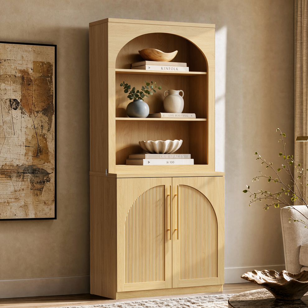 Natural wood bookcase with arched open shelves and fluted double doors.
