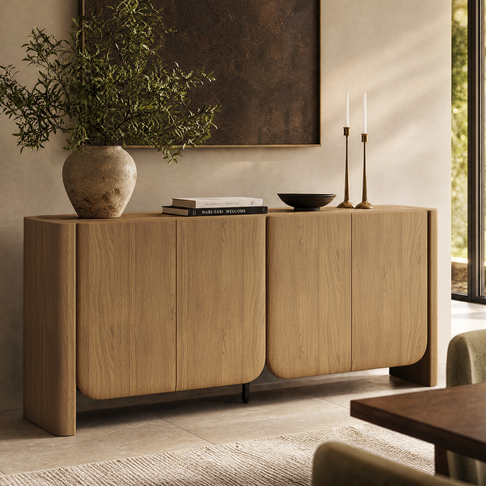 Wood-grain four-door sideboard with rounded lower corners and thick side panels beneath framed artwork