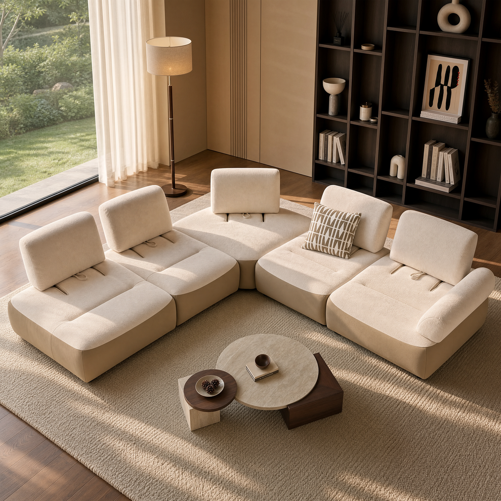 Cream modular sectional sofa arranged around low nesting tables in a sunlit living room.