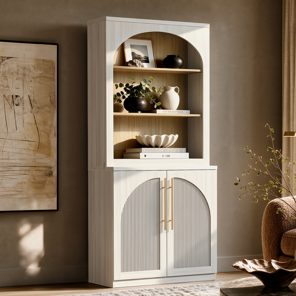 White arched bookcase with open shelves and two ribbed cabinet doors.
