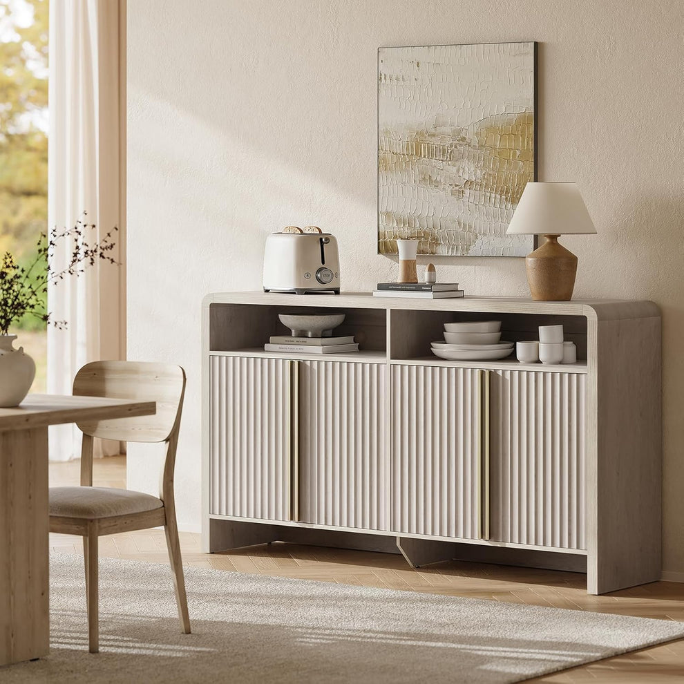 Pale fluted sideboard with gold-tone handles and two open upper compartments holding dishes in a dining room