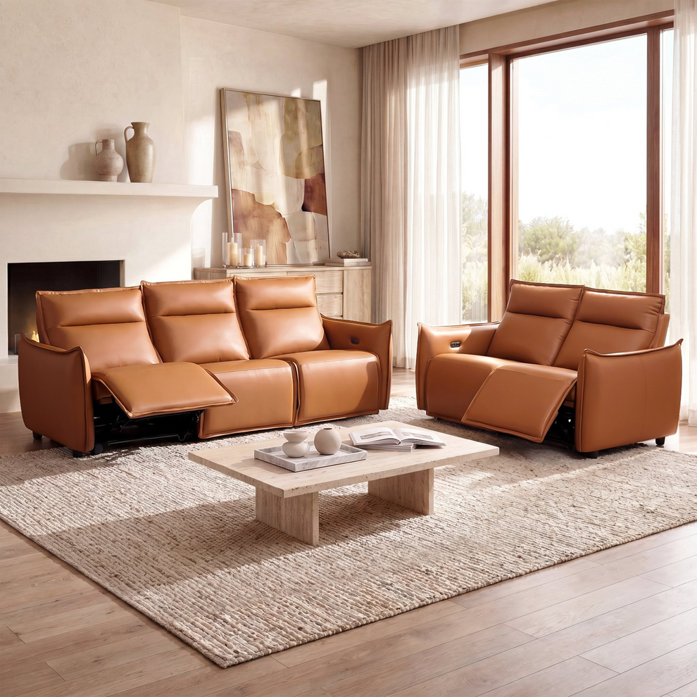 Orange reclining sofa and matching loveseat with extended footrests arranged around a pale coffee table