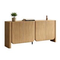 Light wood sideboard with four doors, curved edges, books, a plant, and a wooden ornament.