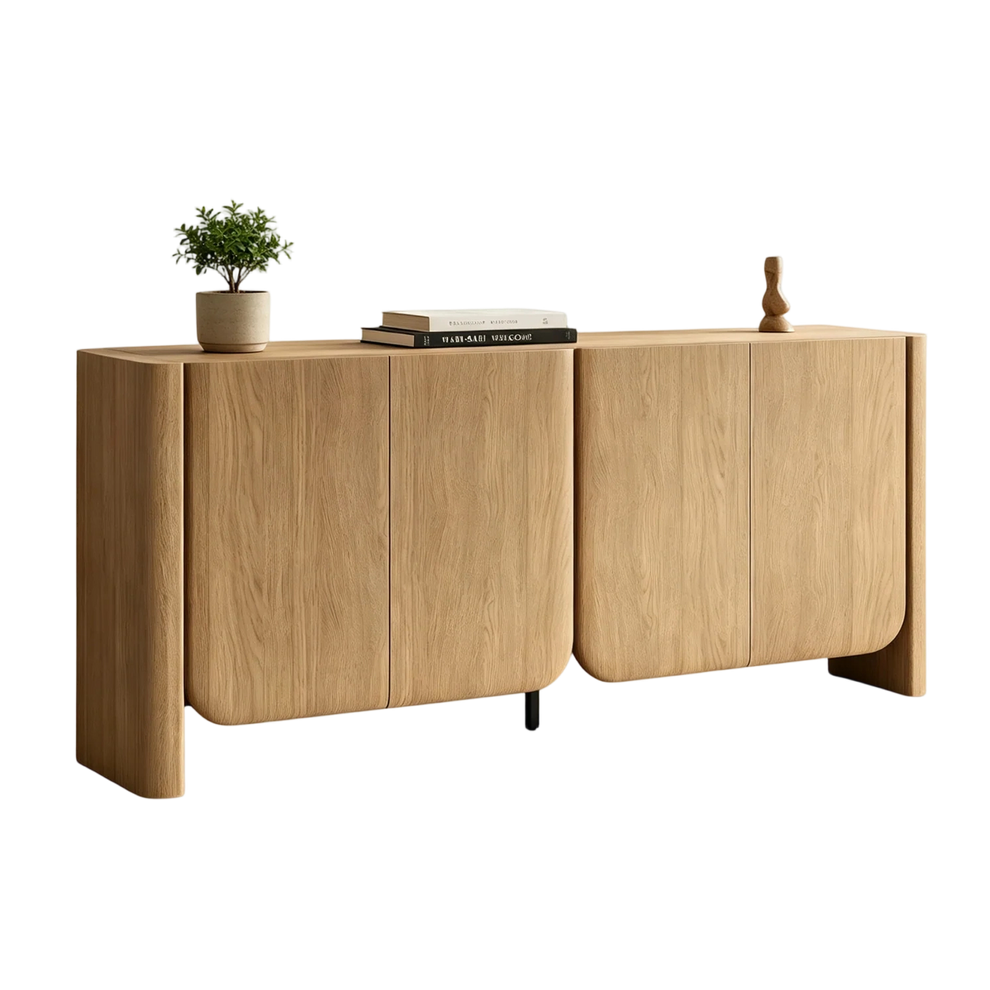 Light wood sideboard with four doors, curved edges, books, a plant, and a wooden ornament.