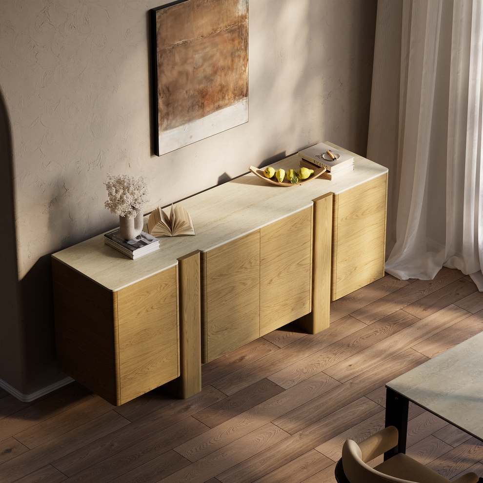 Light wood sideboard with rounded corners and pale stone top in a sunlit room.