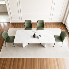 Four dining chairs are arranged around one rectangular table