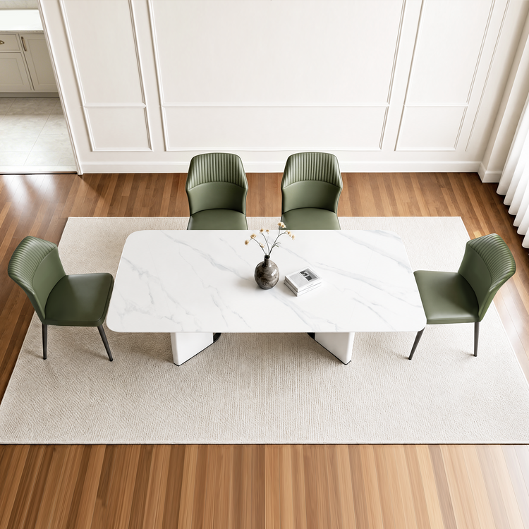 Four dining chairs are arranged around one rectangular table