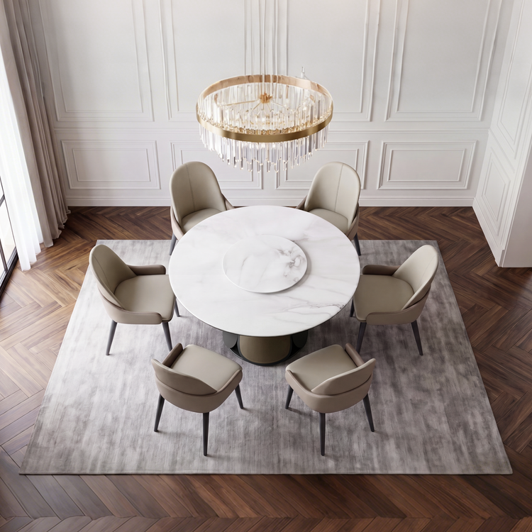 Round table with a smaller center tray is encircled by six chairs, Circular chandelier hangs above the table