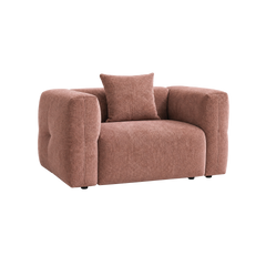 Pink upholstered armchair with wide rounded arms and a matching square cushion.