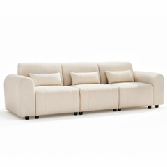 Cream-colored three-seat sofa with rounded arms, three rectangular matching pillows, and short black feet on a white background.