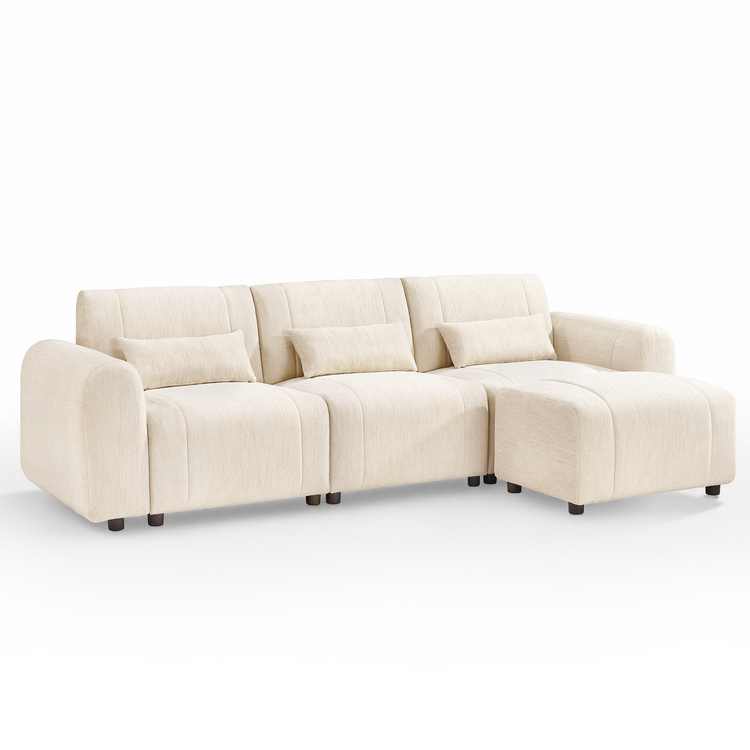 Cream-colored sofa with three back cushions, three rectangular pillows, rounded arms, short dark legs, and a matching ottoman positioned in front of the right seat.