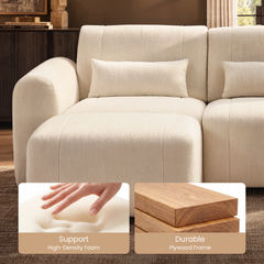 Cream sofa with rounded arm, rectangular pillows and a matching ottoman, with inset photos of a hand pressing into pale cushioning and stacked wood boards.