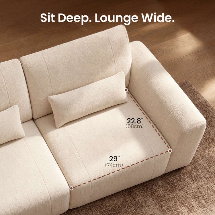 Diagram of a cream sofa seat with a rectangular pillow and rounded armrest, with dashed lines marking seat width as 29 inches (74 cm) and depth as 22.8 inches (58 cm).