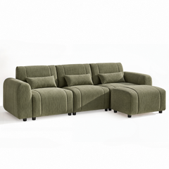 Olive green upholstered sectional sofa with three back cushions, three throw pillows, and a chaise on the right.