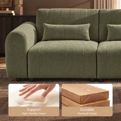 Close-up of a green textured sofa with a rounded arm, rectangular pillows and short black feet, with inset photos of a hand pressing foam and stacked wood boards.