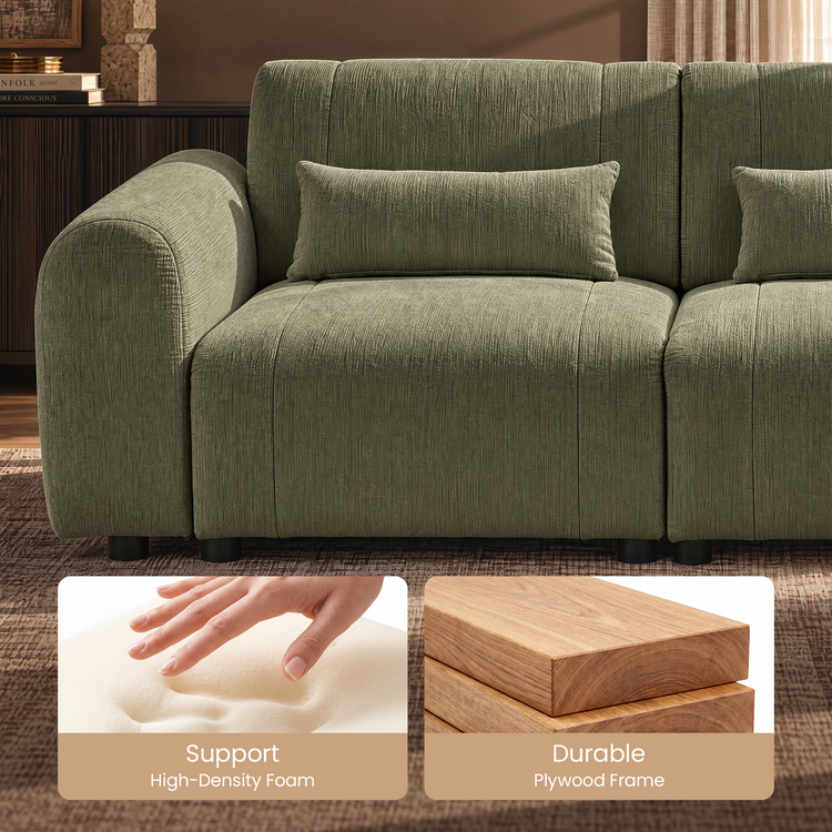 Close-up of a green textured sofa with a rounded arm, rectangular pillows and short black feet, with inset photos of a hand pressing foam and stacked wood boards.