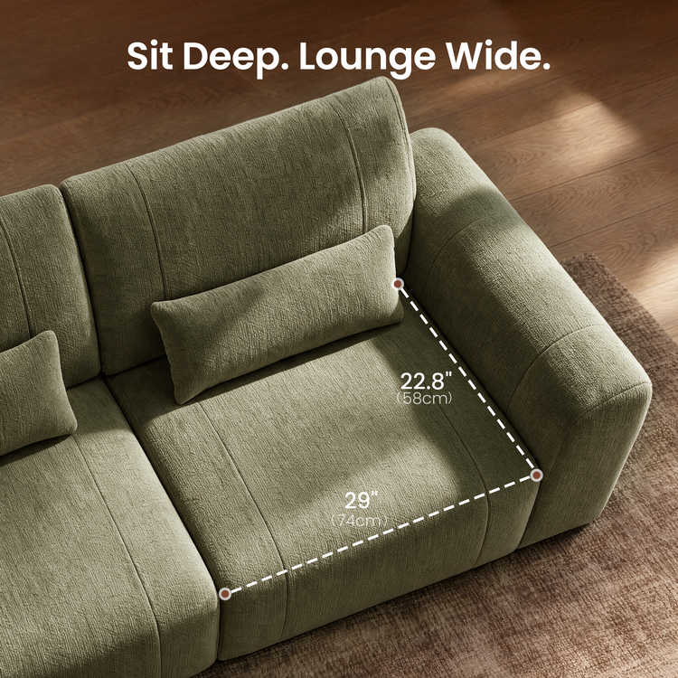 Diagram of a green sofa seat with a rectangular pillow and dashed lines marking a width of 29 inches (74 cm) and depth of 22.8 inches (58 cm).