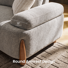 Close-up of a light gray upholstered chair with a rounded armrest and wooden support; an overlay marks the armrest as 13 inches (33 cm) wide.