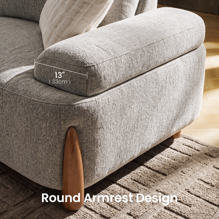 Close-up of a light gray upholstered chair with a rounded armrest and wooden support; an overlay marks the armrest as 13 inches (33 cm) wide.