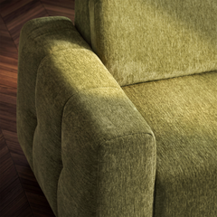 Close-up of olive-green upholstered seating with a rounded, segmented armrest, textured fabric, and visible seams beside the seat and back cushion.