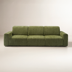 Front view of an olive-green sofa with three seat cushions, three back cushions, and broad padded arms against a plain cream background.