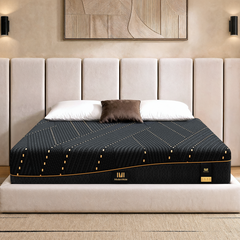 Dark patterned mattress has gold-colored edge accents, White pillows rest along the head of the bed
