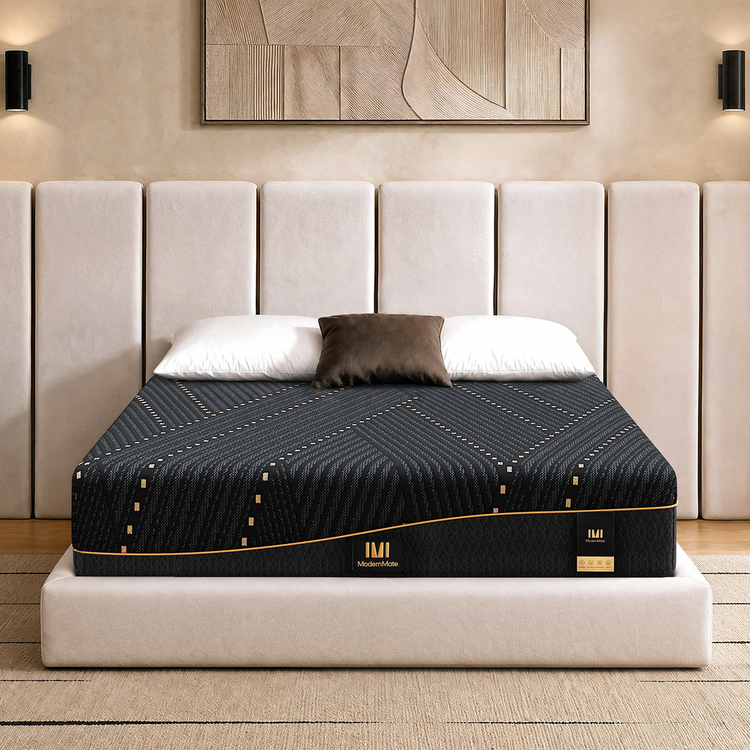 A patterned mattress rests on a platform bed beneath three pillows and a tall paneled headboard