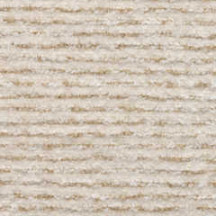 Close-up of a cream-colored, shaggy surface with irregular horizontal ridges and darker beige fibers.