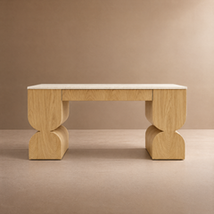 Light wood console table with sculpted pedestal legs and a pale stone top.