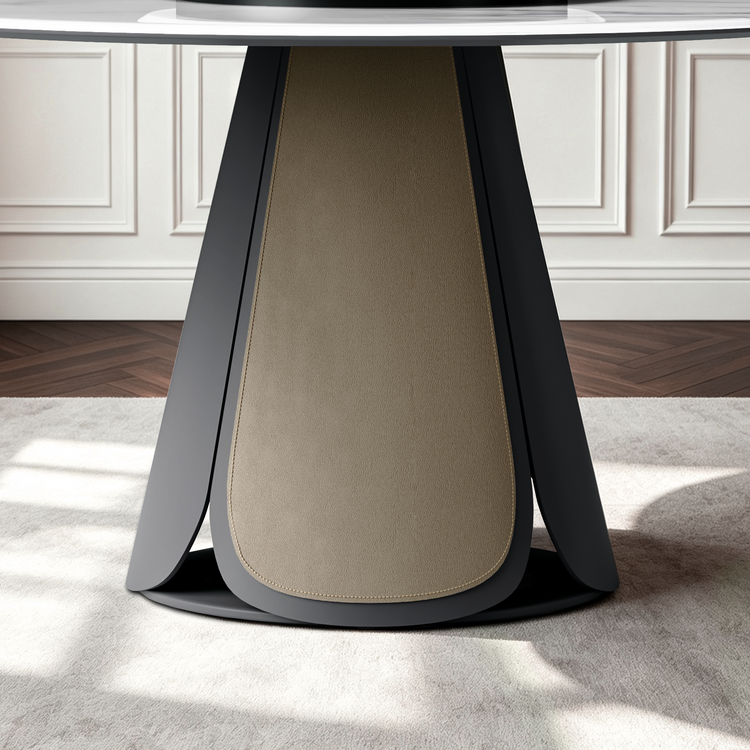 Close view of a table base with two dark angled outer panels surrounding a pale rounded central pedestal