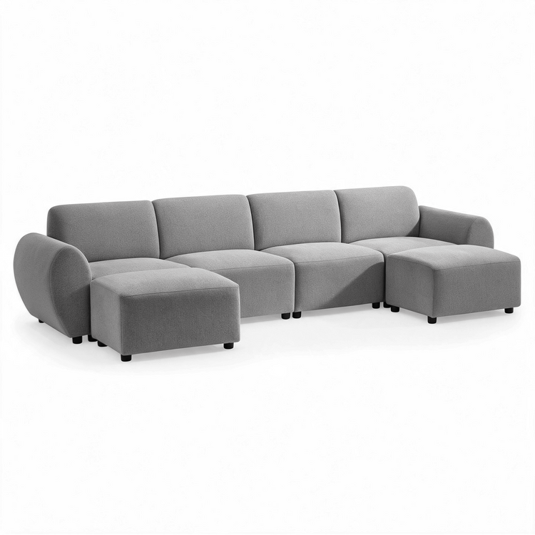 Gray sofa with four back cushions, rounded arms, short black feet, and two matching ottomans positioned in front of the outer seats.