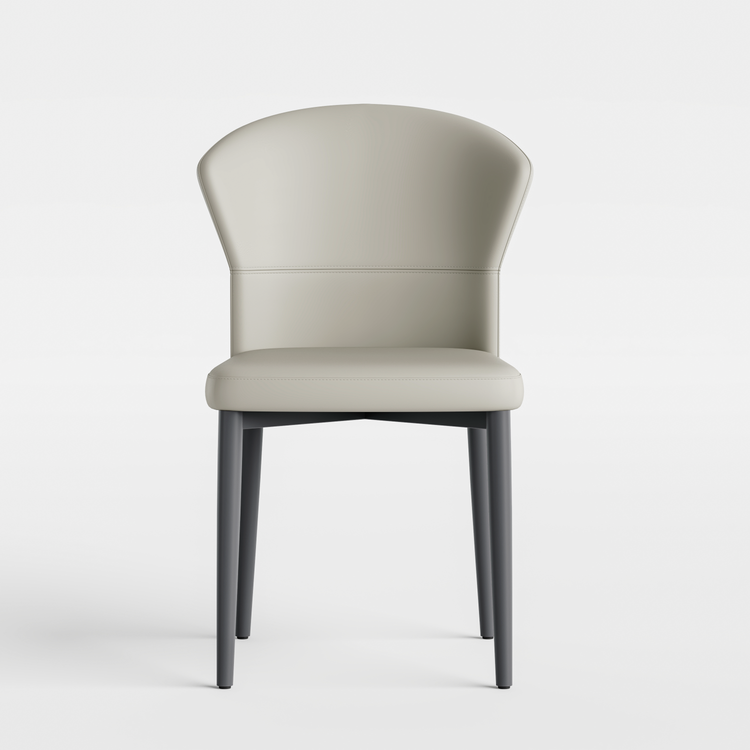 Light chair has a curved wraparound back, padded seat, and four dark tapered legs