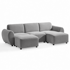 Gray sofa with three back cushions, rounded arms and short black feet, with two matching rectangular ottomans positioned in front of the outer seats.