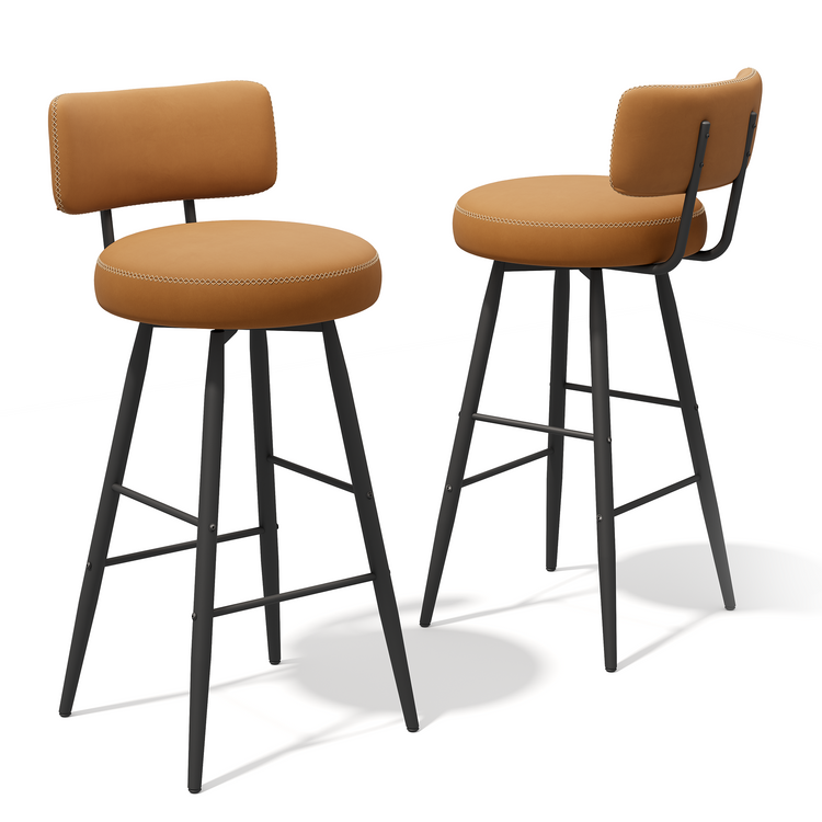 Two tan upholstered bar stools with slim black legs, footrests, and curved backs on white