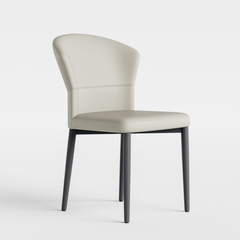Pale upholstered armless chair has a curved back and four long dark tapered legs