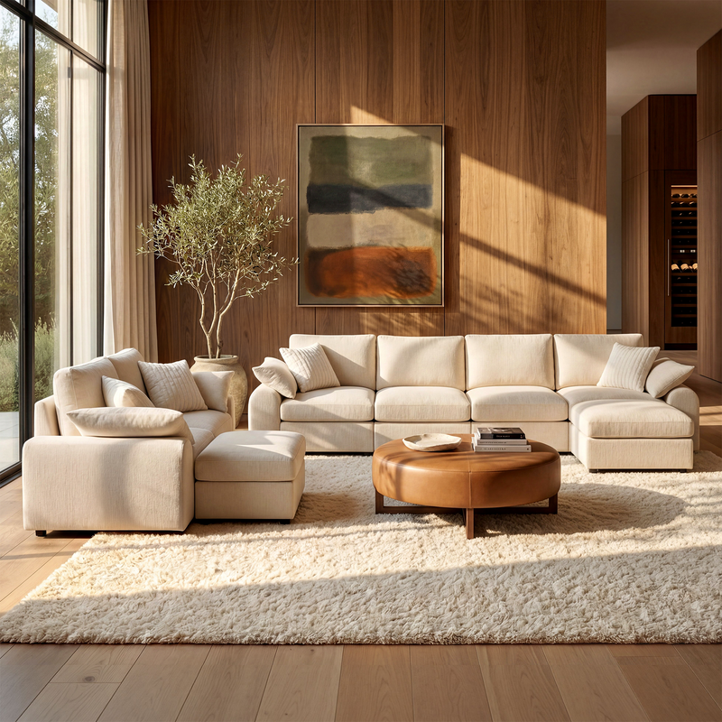 Beige modular sofa set with chaise and ottoman in a sunlit living room