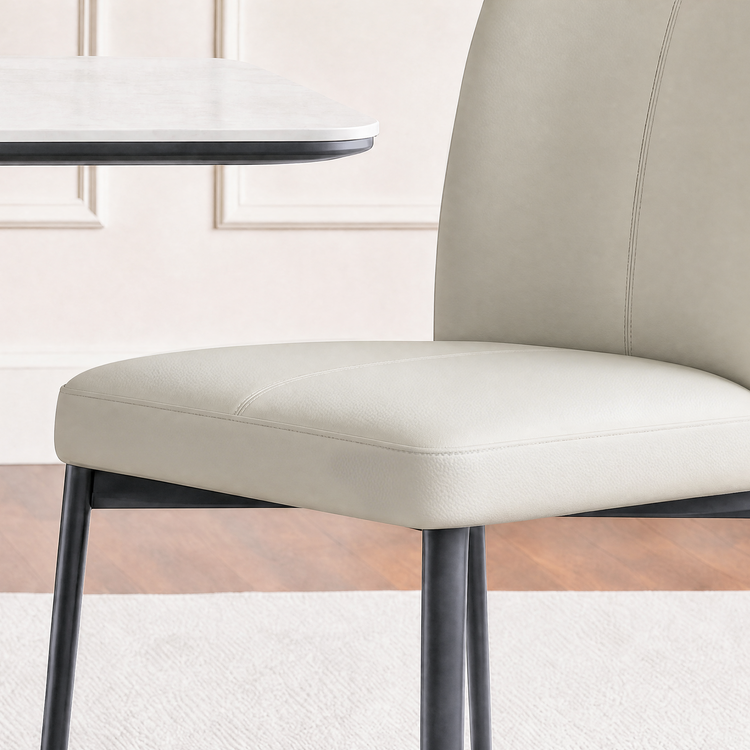 Stitched seams outline the chair seat and back, A table edge is cropped at upper left