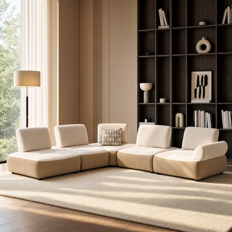 Cream modular sectional sofa in a sunlit living room with dark shelving.