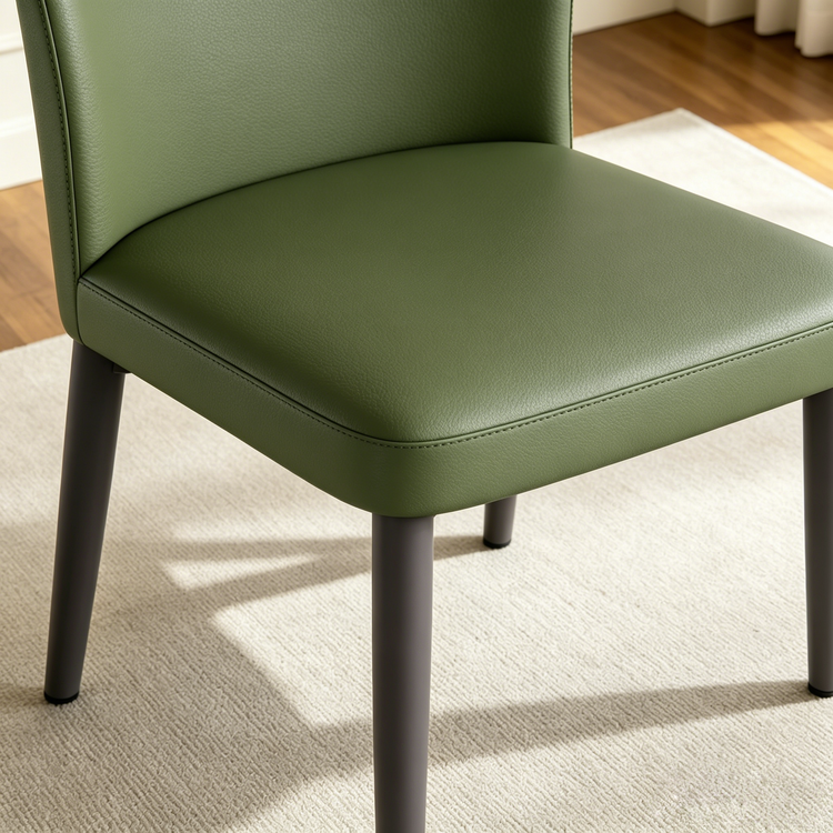 The chair fills the close-up frame, Stitched seams outline the seat and back