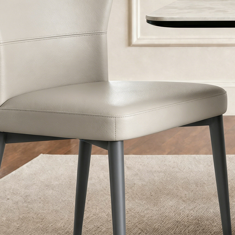 Light upholstered dining chair shown in a close detail view