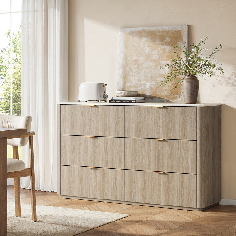 Light wood-toned dresser shown beneath wall art in a bedroom
