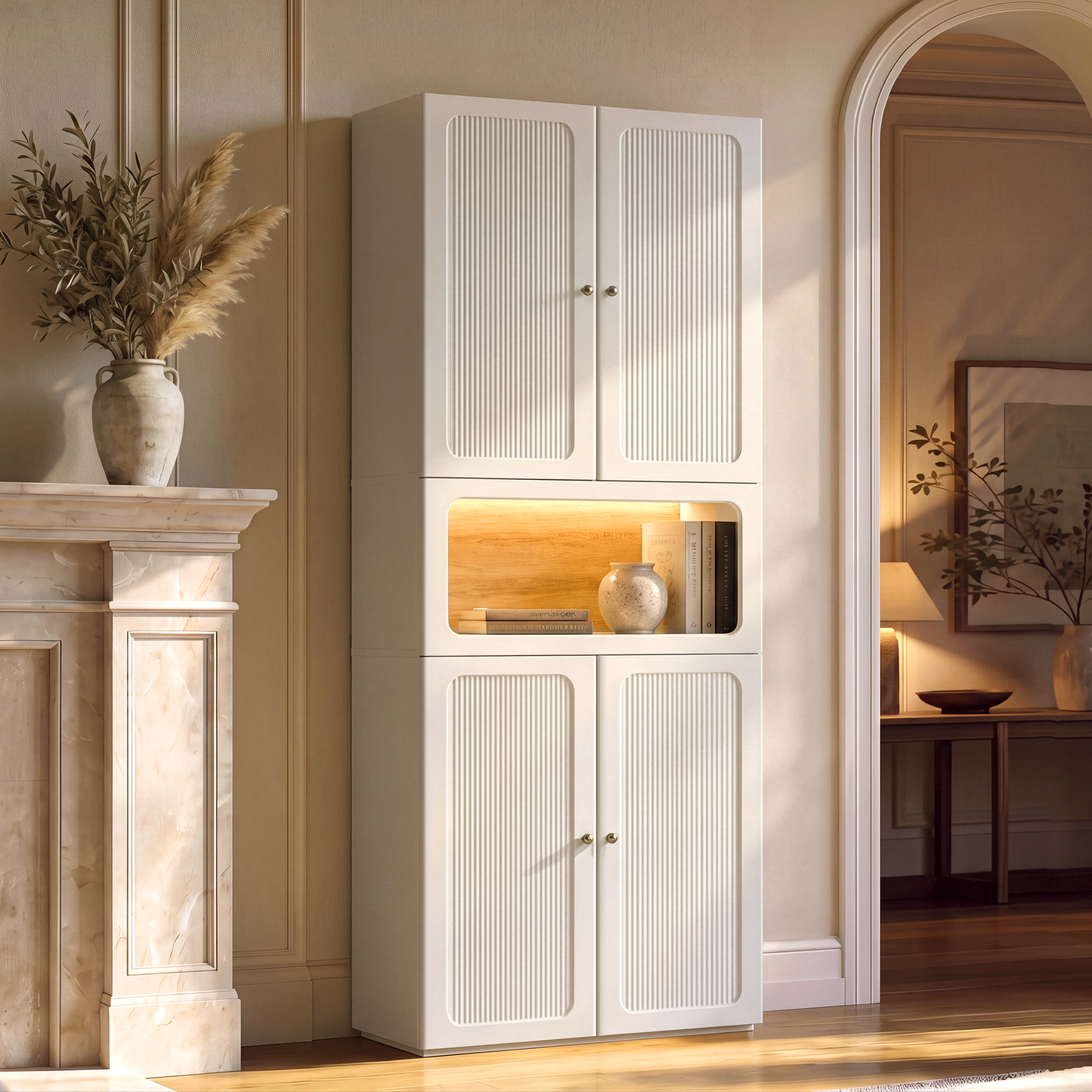 Tall white cabinet has four fluted doors and a lit open center niche