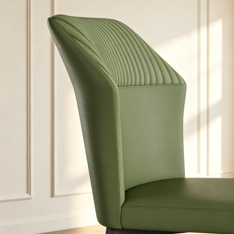 Green upholstered chair back has curved side panels and vertical channel stitching
