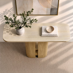 Rounded rectangular console table with a pale stone top and wood pedestal base.