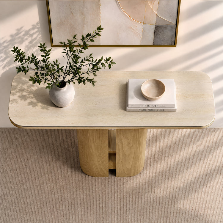 Rounded rectangular console table with a pale stone top and wood pedestal base.