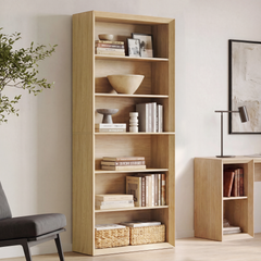 Tall light wood-toned bookshelf shown in a room