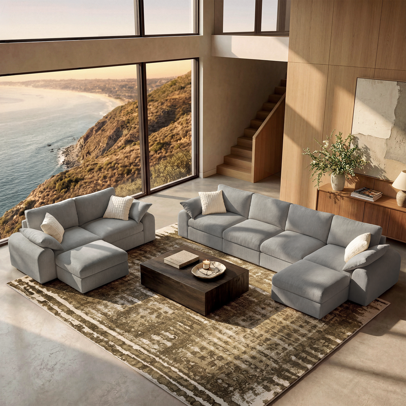 Gray modular sofa set with ottomans in a sunlit coastal living room