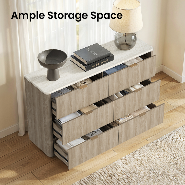 Six open drawers arranged in three rows reveal folded clothing inside a light wood-tone dresser