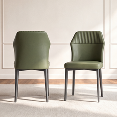 Two green dining chairs with vertically stitched upper backs and dark legs, shown from the front and rear