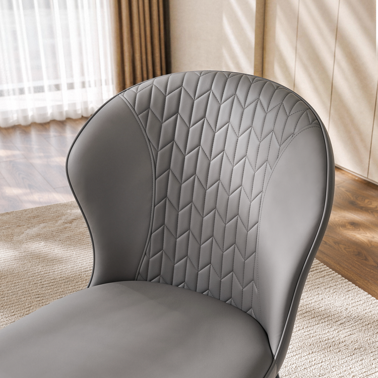 Gray upholstered chair shown in a close detail view